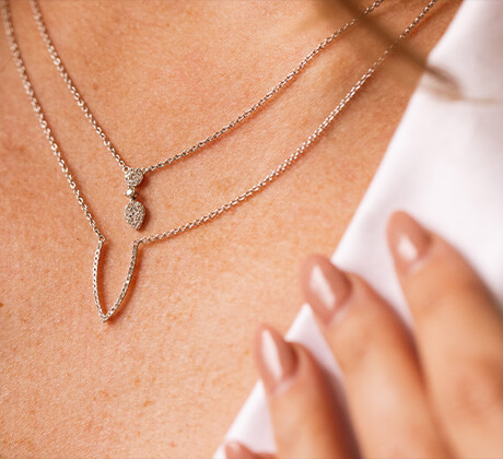 woman wearing diamond necklaces